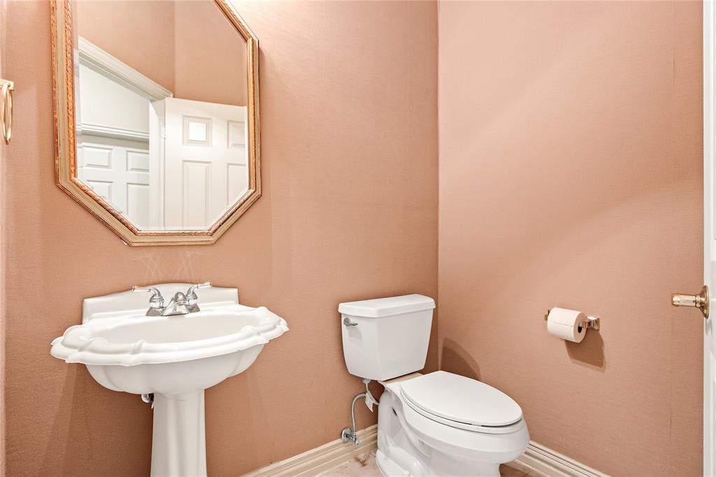 1614 Villa Court Corinth, TX 76210 - Photo 8 of 17 Half bath with toilet and baseboards Located on first floor.