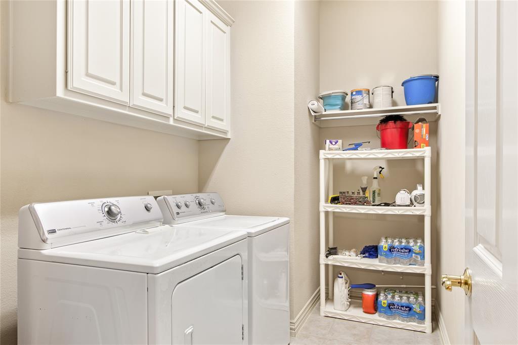 1614 Villa Court Corinth, TX 76210 - Photo 9 of 17 Laundry room with cabinet space, independent washer and dryer, and light tile patterned flooring