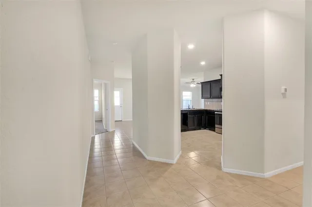 a view of entryway and kitchen with a sink