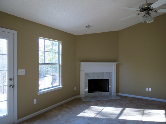 3390 Trotters Ridge Trail Gray, GA 31032 - Photo 3 of 13 a view of an empty room with a fireplace and a window