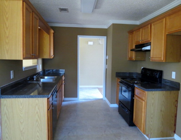 3390 Trotters Ridge Trail Gray, GA 31032 - Photo 5 of 13 a kitchen with stainless steel appliances granite countertop a sink stove and refrigerator