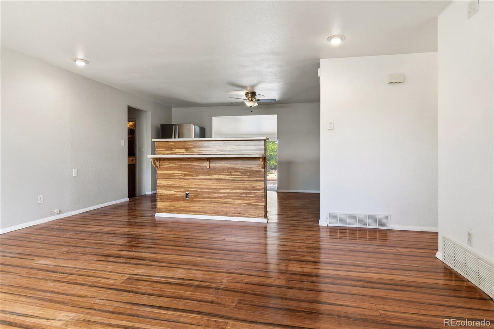 7461 Webster Street Arvada, CO 80003 - Photo 6 of 31 a view of room and wooden floor