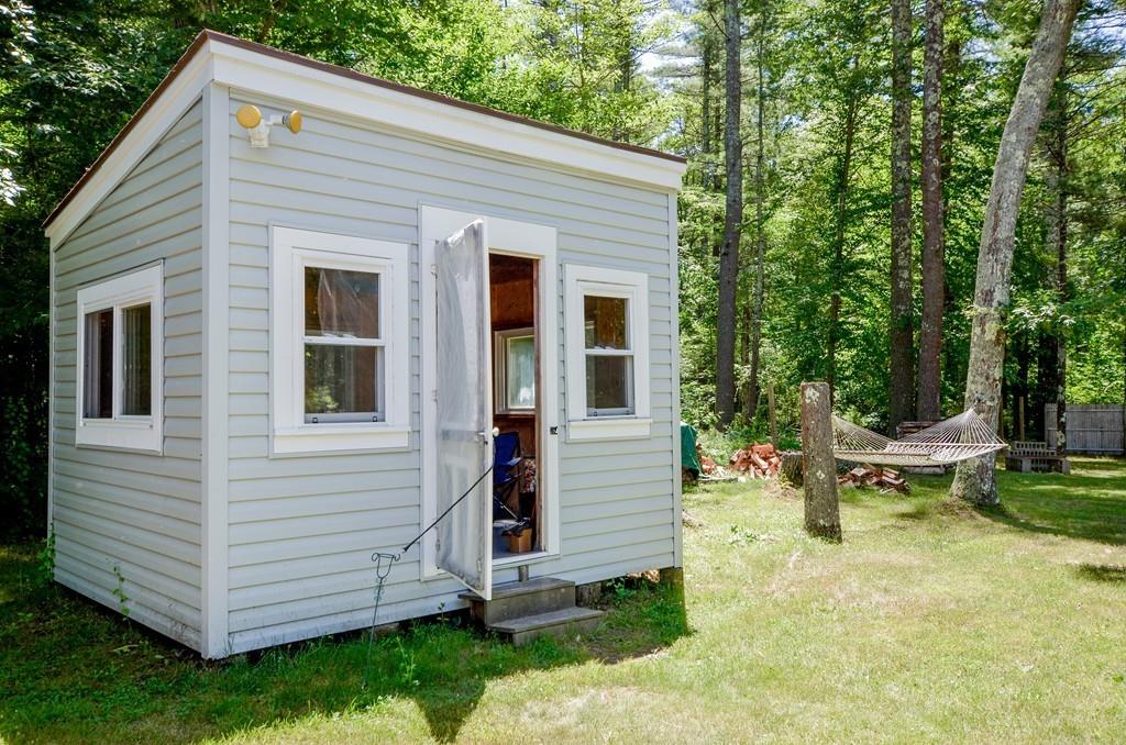 899 Walnut Plain Road Rochester, MA 02770 - Photo 11 of 42 a view of a house with backyard sitting area and garden