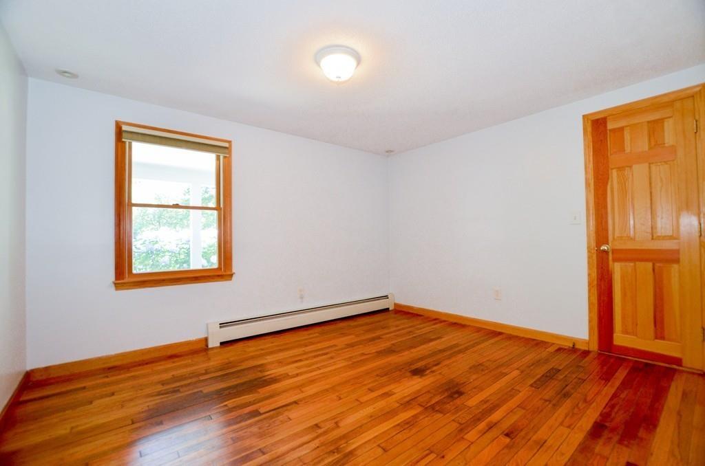 899 Walnut Plain Road Rochester, MA 02770 - Photo 27 of 42 a view of an empty room with wooden floor and a window