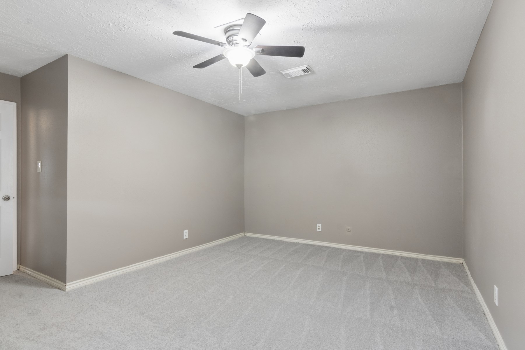 2607 Allyson Court Spring, TX 77373 - Photo 18 of 25 an empty room with a chandelier fan and windows