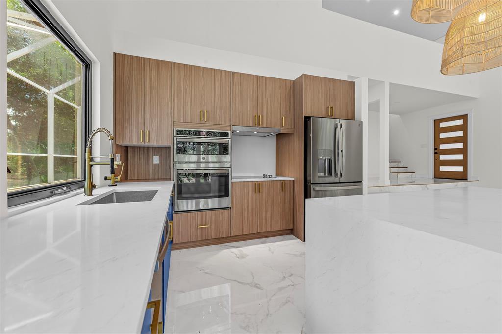 15184 Alexander Run Jupiter, FL 33478 - Photo 16 of 46 a kitchen with stainless steel appliances a refrigerator and a stove top oven