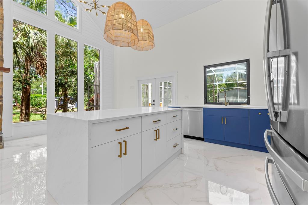 15184 Alexander Run Jupiter, FL 33478 - Photo 19 of 46 a bathroom with a double vanity sink a two mirror a window and a bathtub