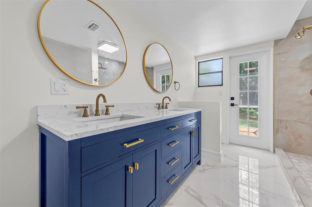 15184 Alexander Run Jupiter, FL 33478 - Photo 23 of 46 a bathroom with a double vanity sink and a mirror