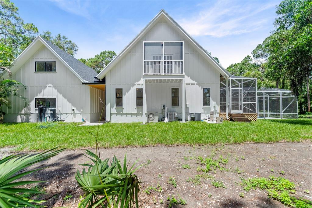 15184 Alexander Run Jupiter, FL 33478 - Photo 43 of 46 a front view of a house with a yard and porch