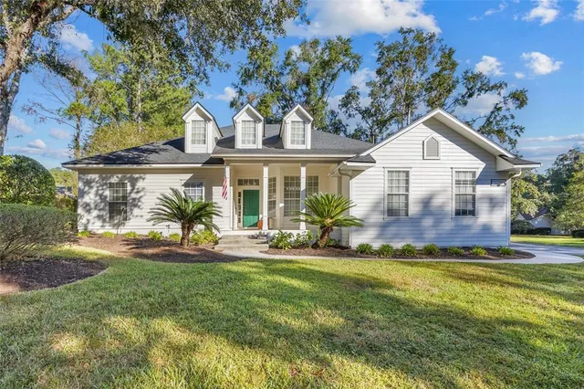 a view of a house with a big yard and potted plants