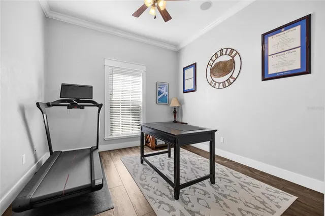 a view of a workspace with furniture and a window