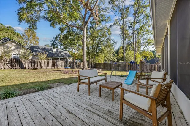 a view of a wooden chairs and table on the deck