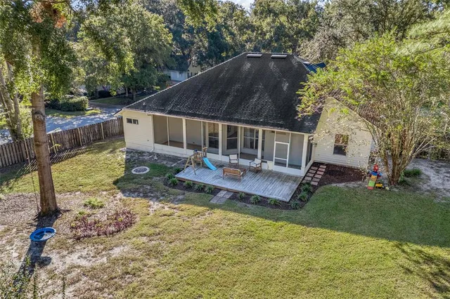 a backyard of a house with yard table and chairs