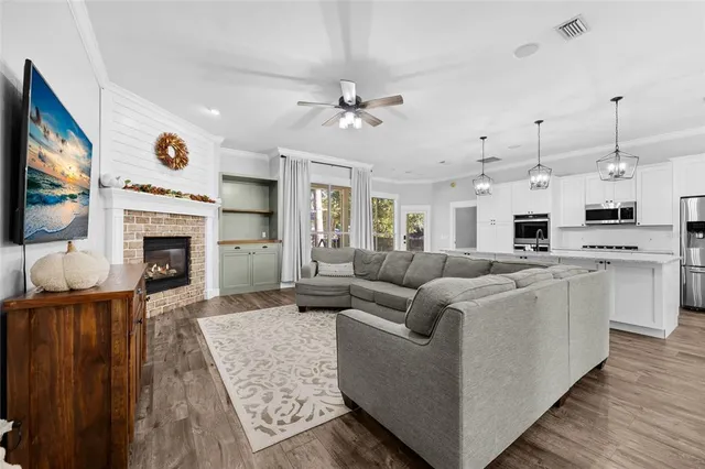 a living room with furniture a fireplace and a flat screen tv