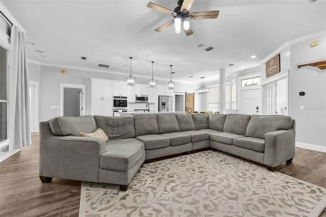 a living room with furniture and a chandelier