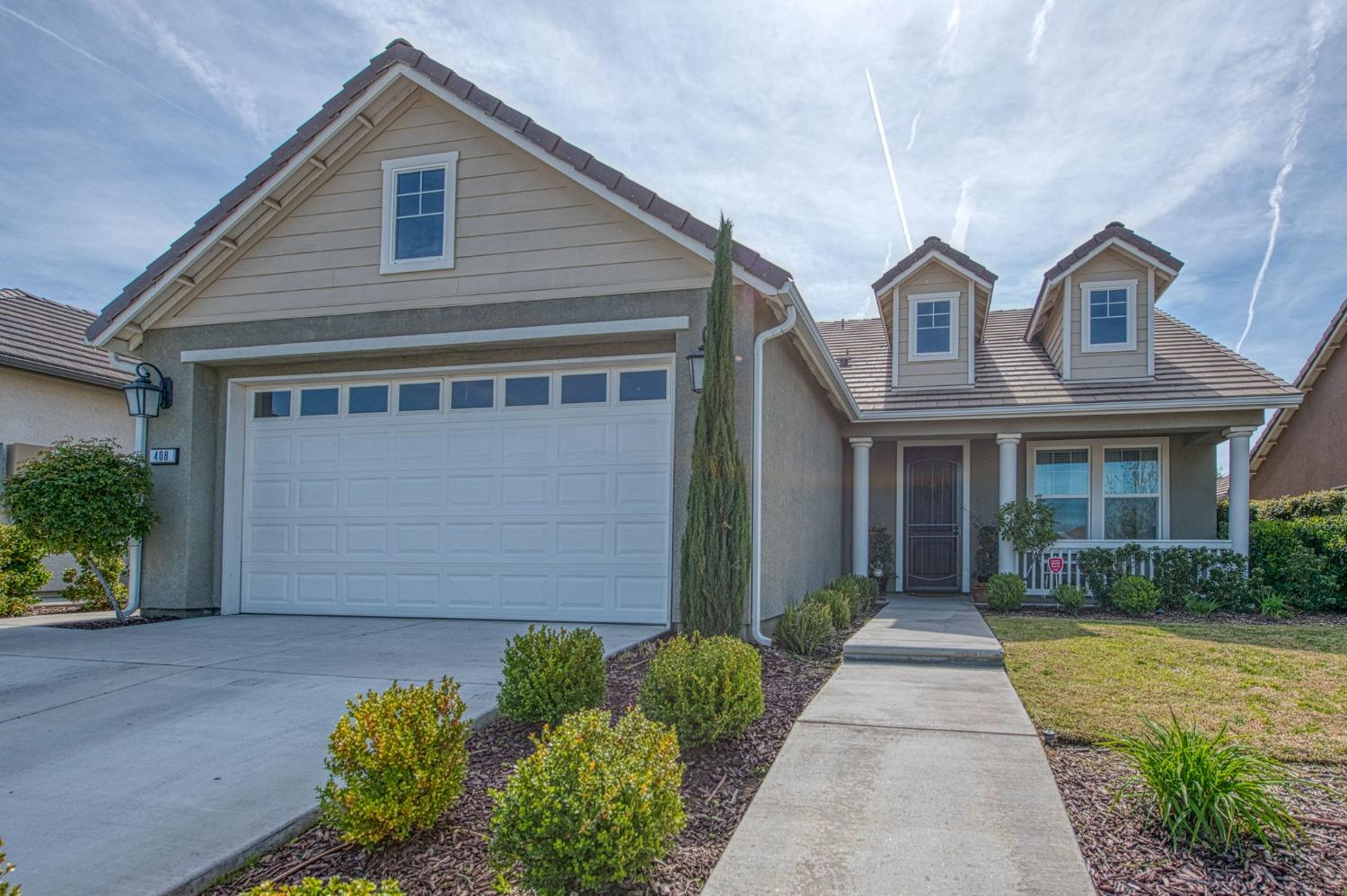 a front view of a house with garden