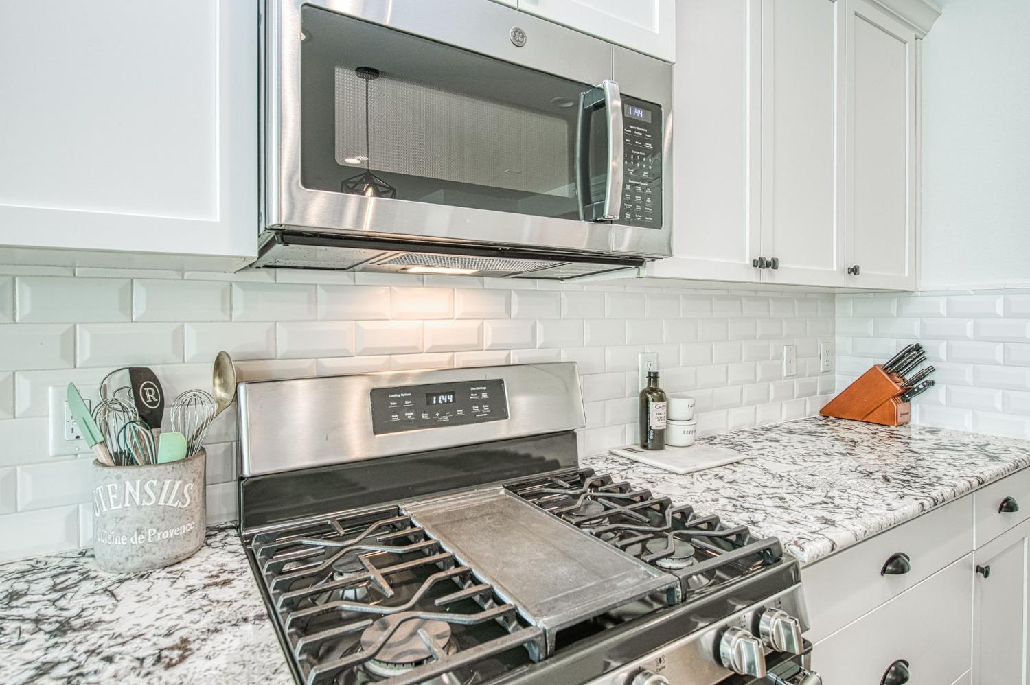 408 Grant Avenue West Madera, CA 93636 - Photo 13 of 42 a kitchen with stove top oven and cabinets