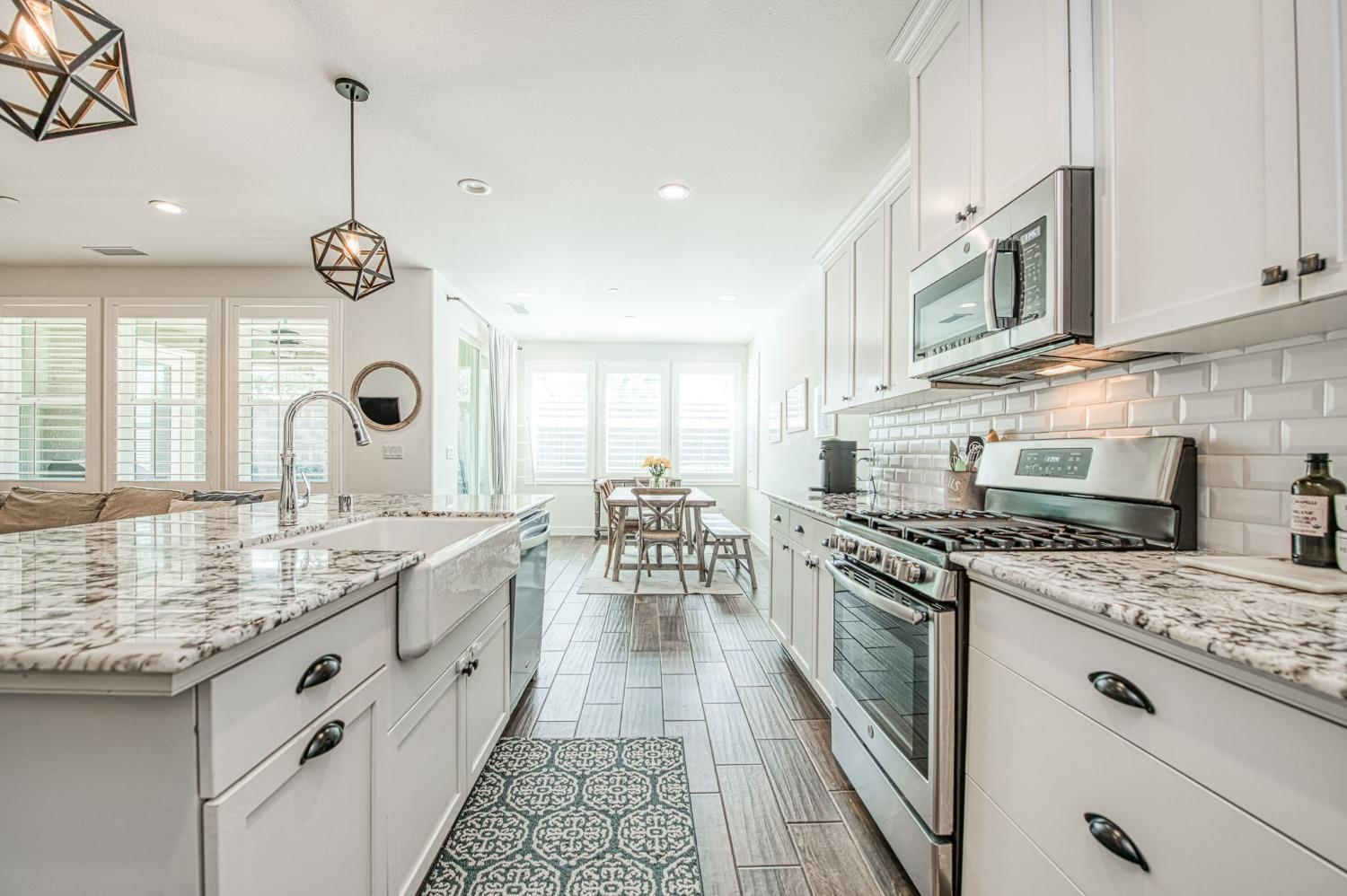 408 Grant Avenue West Madera, CA 93636 - Photo 14 of 42 a kitchen with stainless steel appliances granite countertop a stove a sink and a microwave