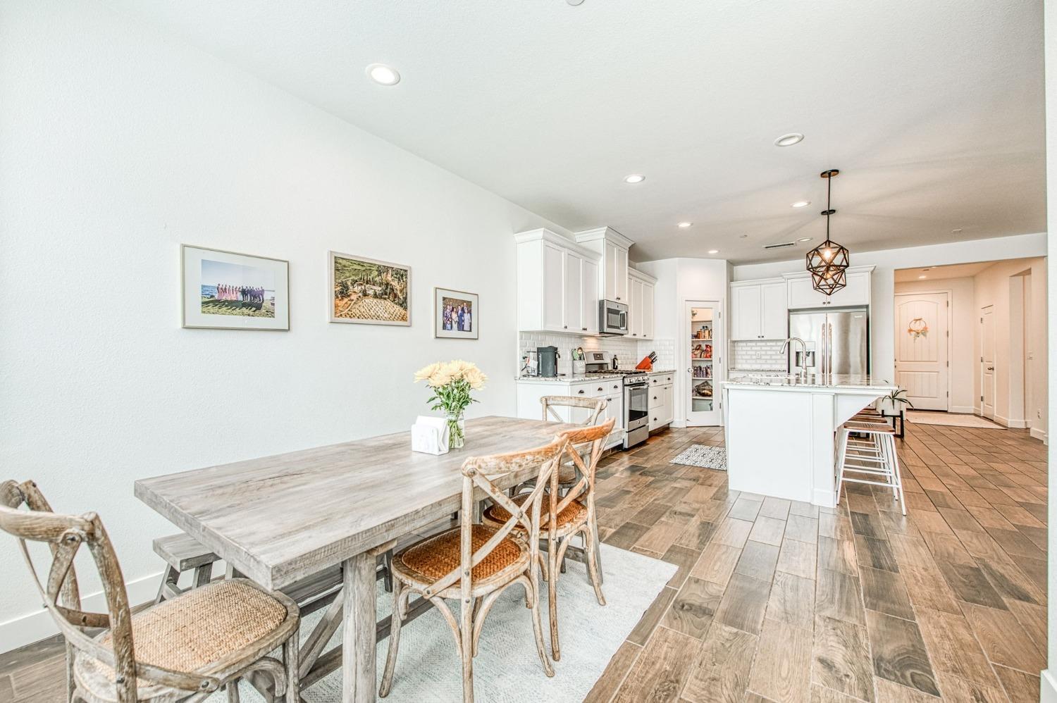 408 Grant Avenue West Madera, CA 93636 - Photo 16 of 42 a view of a dining room with furniture and wooden floor
