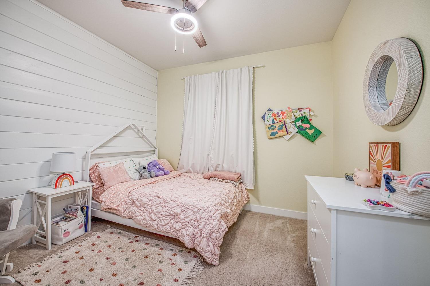 408 Grant Avenue West Madera, CA 93636 - Photo 21 of 42 a bedroom with a bed and a chandelier