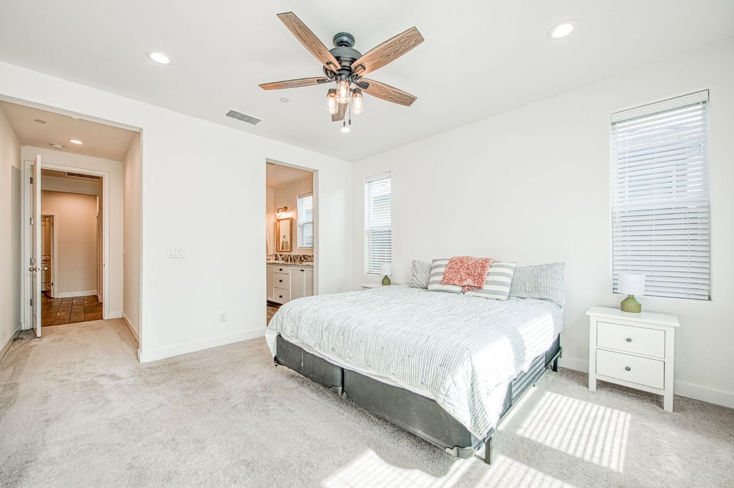 408 Grant Avenue West Madera, CA 93636 - Photo 24 of 42 a bedroom with a large bed and a chandelier