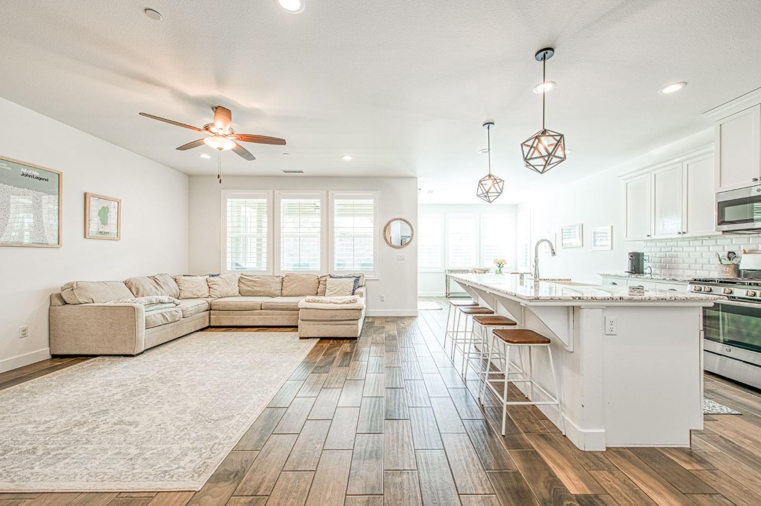 408 Grant Avenue West Madera, CA 93636 - Photo 6 of 42 a living room with kitchen island furniture and a chandelier