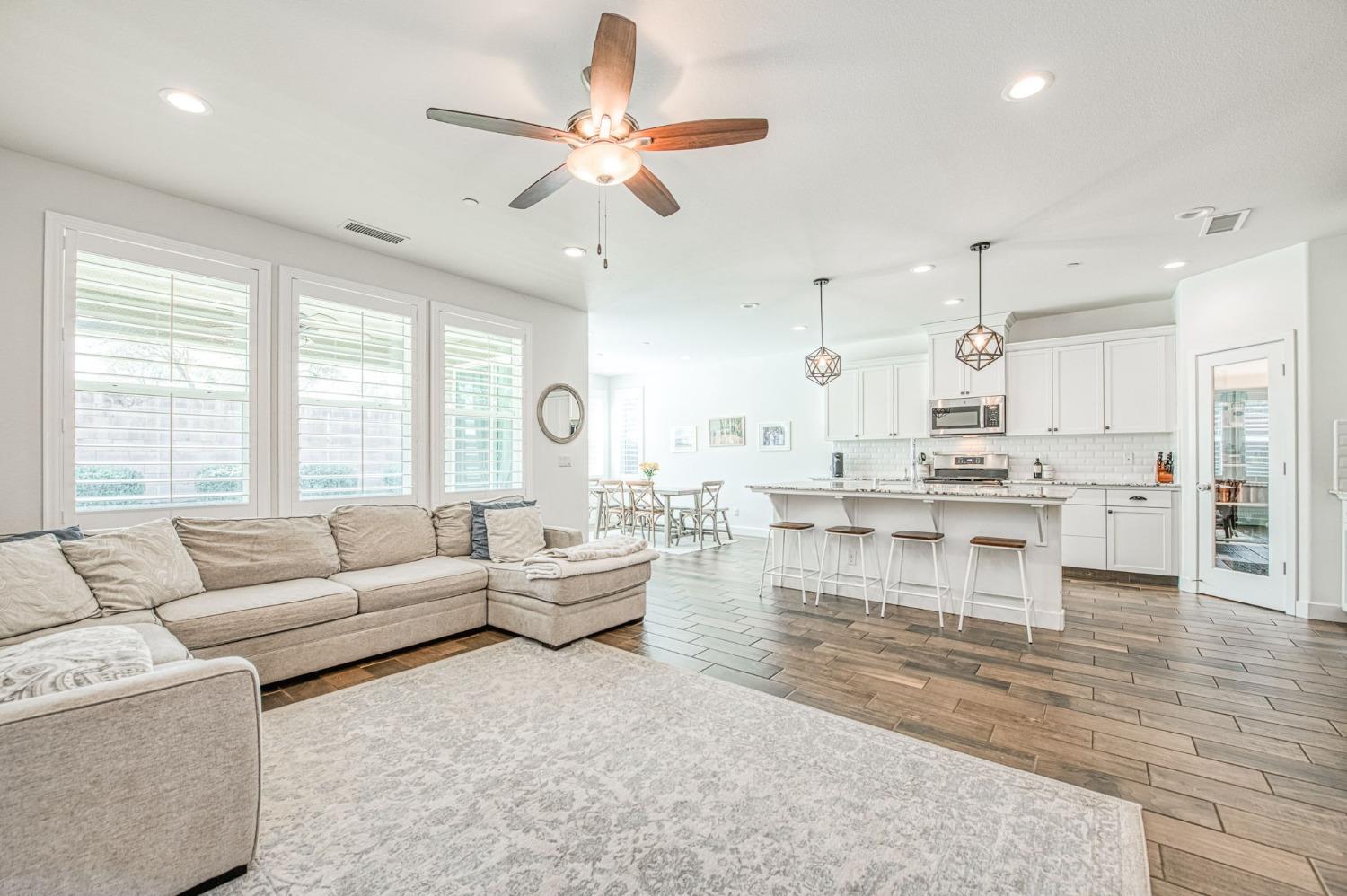 408 Grant Avenue West Madera, CA 93636 - Photo 7 of 42 a living room with couches and kitchen view with wooden floor