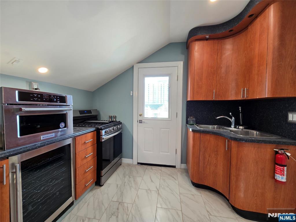 282 Harding Avenue, Unit 2 Teaneck, NJ 07666 - Photo 14 of 17 a kitchen with stainless steel appliances granite countertop a stove a sink and a microwave