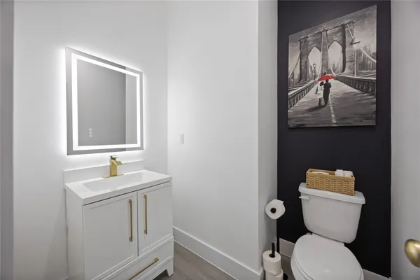 a bathroom with a toilet sink and mirror