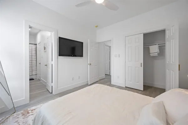 a bedroom with a bed and a flat screen tv