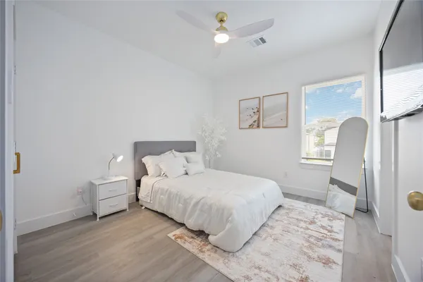 a bedroom with a bed and a lamp