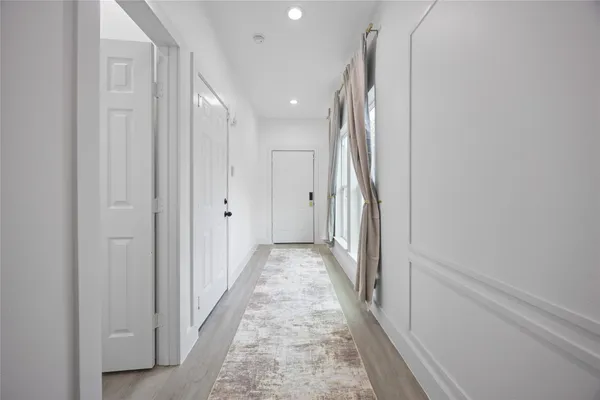a view of a hallway with white walls