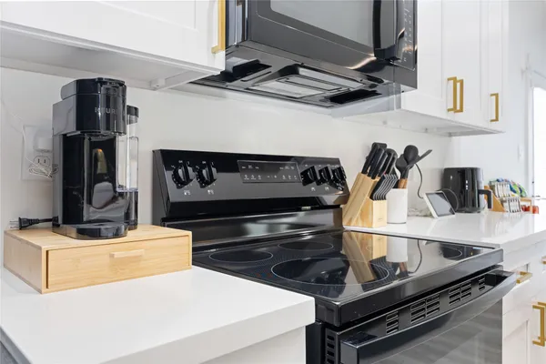 a kitchen with a stove a faucet and a stove