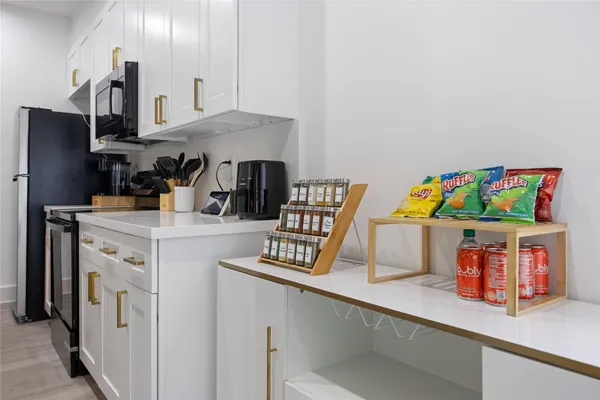 a kitchen with sink cabinets and appliances