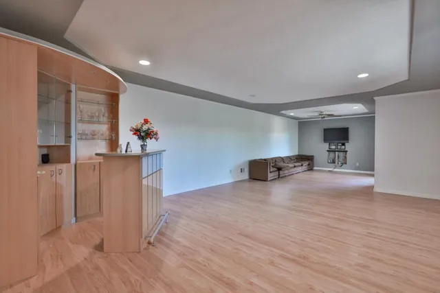 a view of a livingroom with wooden floor and a cabinet