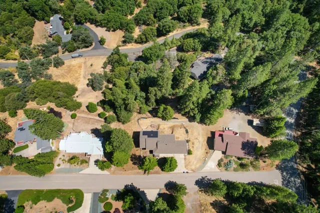 an aerial view of residential houses with outdoor space and street view