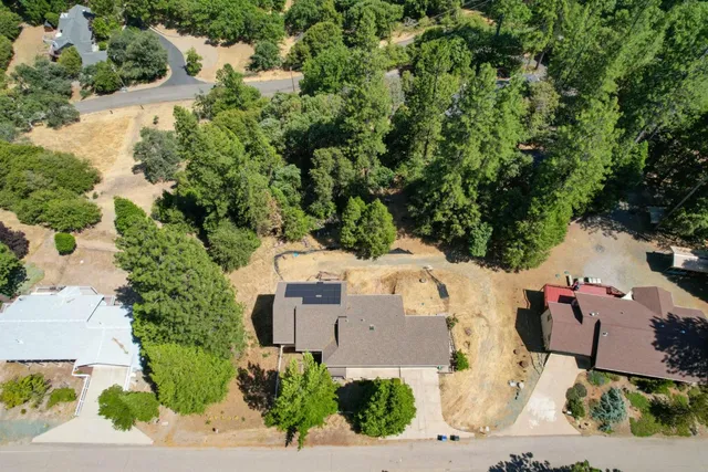 an aerial view of a house with a yard