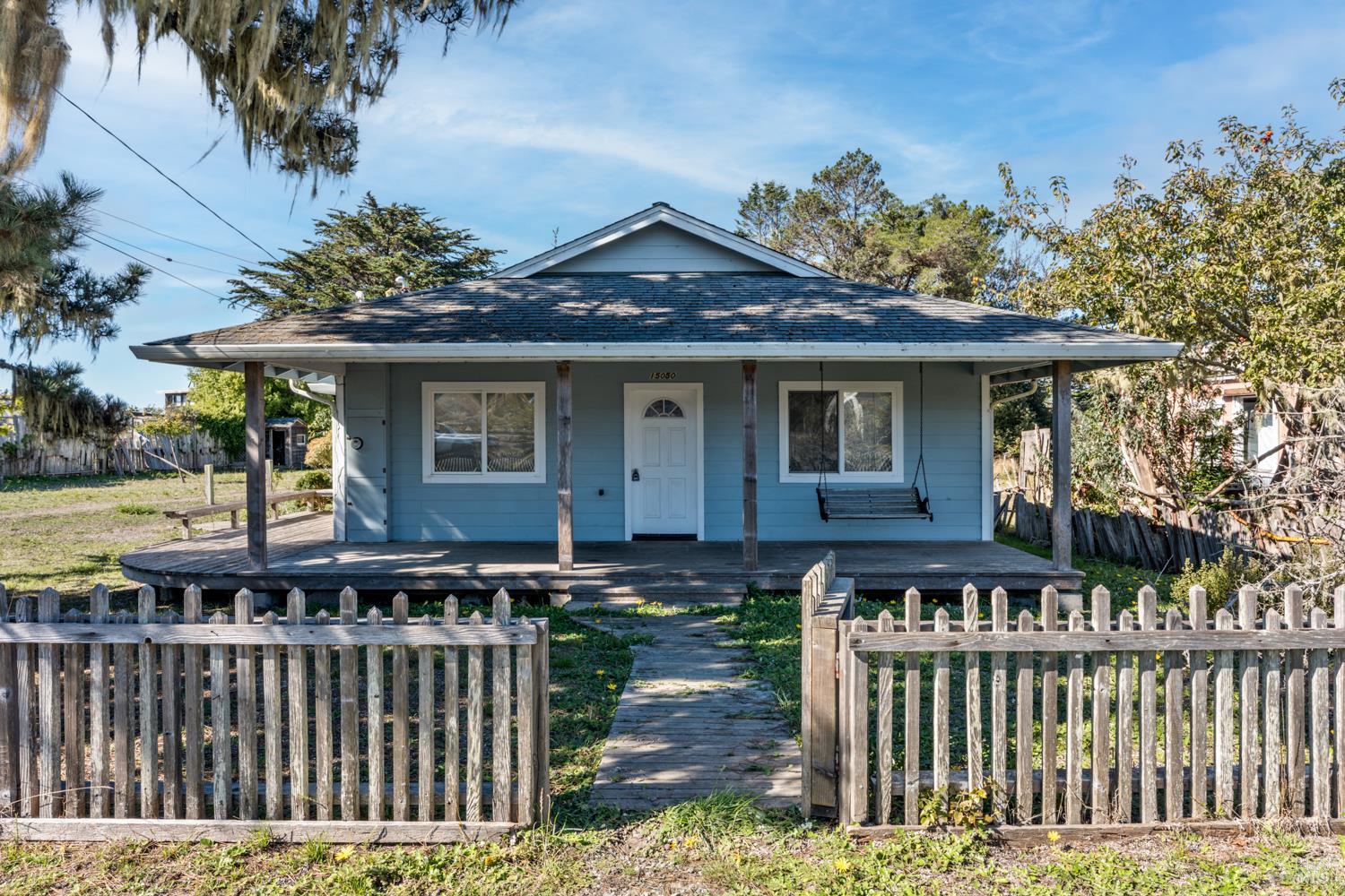 a front view of a house with a garden