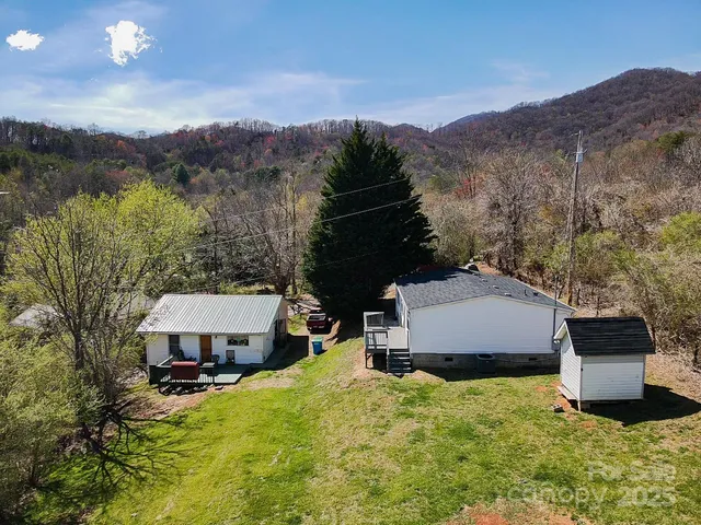 a view of a house with a yard and mountain