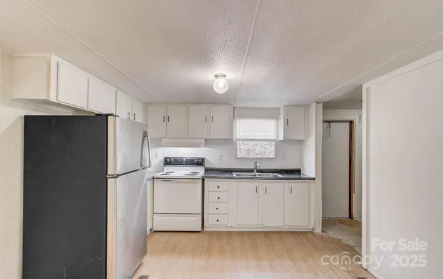 an empty room with wooden floor and ceiling fan