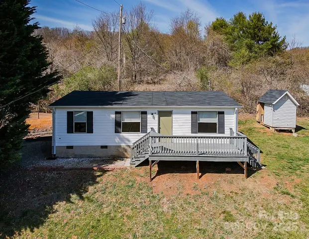 a front view of a house with a yard covered in snow