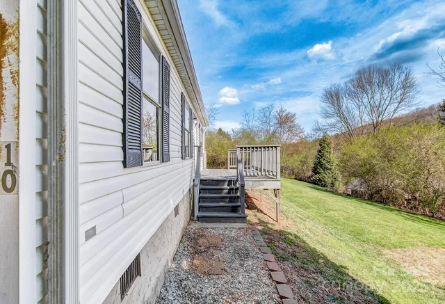 a view of a small house with a yard