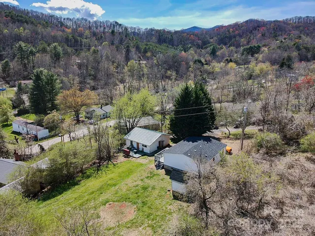 a view of a house with a yard and sitting area