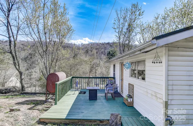 a view of a patio with couches chairs and wooden floor