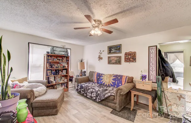a view of hallway with livingroom and stairs