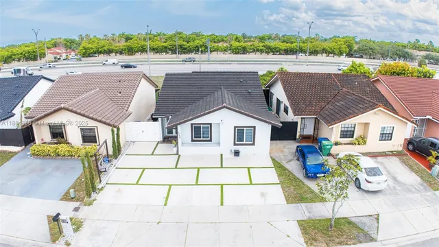 a view of multiple houses with a yard