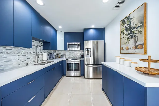 a metallic refrigerator freezer sitting in a kitchen