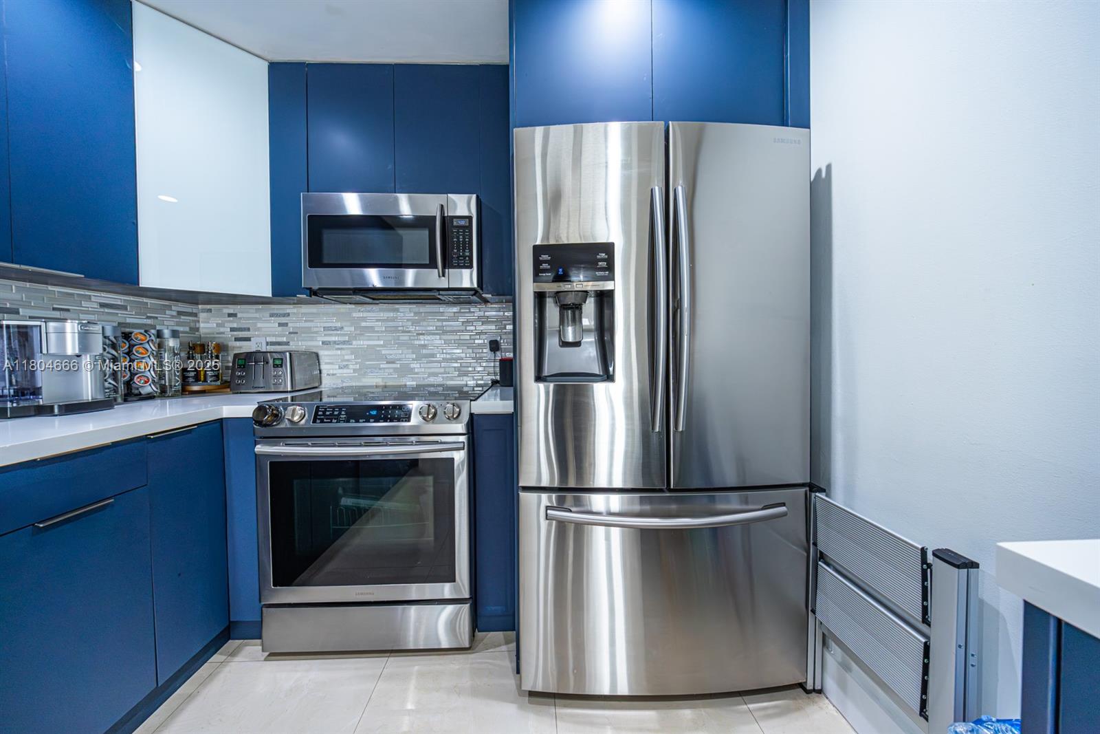 6950 Northwest 168th Street Hialeah, FL 33015 - Photo 14 of 28 a metallic refrigerator freezer sitting in a kitchen