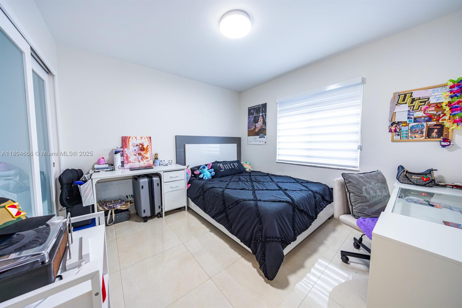 6950 Northwest 168th Street Hialeah, FL 33015 - Photo 17 of 28 a bedroom with a bed and a window
