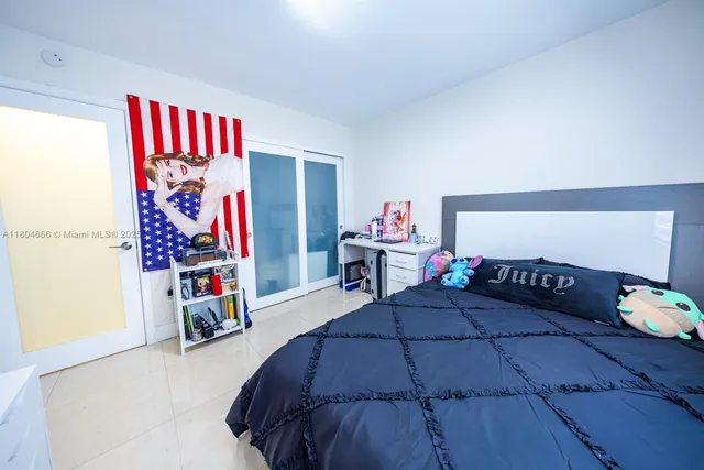 a bedroom with two beds and a desk